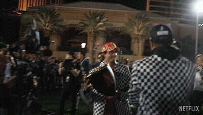 Man In Checkered Jacket Holding Trophy GIF