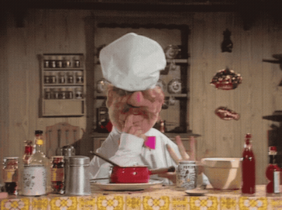 Man In Chef Hat Sitting At Kitchen Table GIF