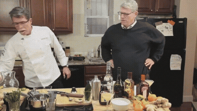 Man In Chef Jacket Next To Man In Sweater GIF