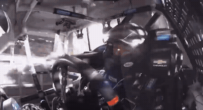 Man In Chevrolet Helmet Driving Race Car GIF