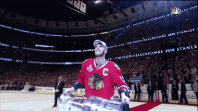 Man In Chicago Blackhawks Jersey Holding Trophy GIF