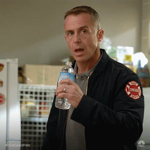 Man In Chicago Fire Department Jacket Holding Water Bottle GIF