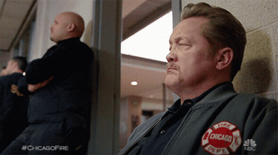 Man In Chicago Fire Department Jacket Looking Out Window GIF