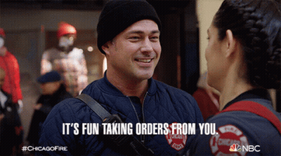 Man In Chicago Fire Department Jacket Talking To Woman GIF