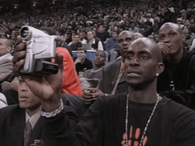 Man In Chicago Shirt Holding Video Camera GIF