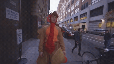 Man In Chicken Costume Saying Yoohoo On Street GIF