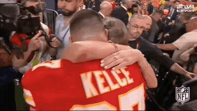Man In Chiefs Jersey Hugging Woman GIF