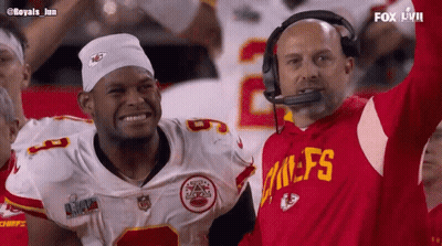 Man In Chiefs Jersey Next To Man With White Headband GIF
