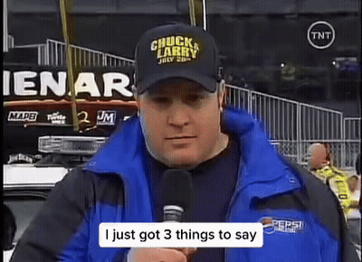 Man In Chuck Larry Hat Talking Into Microphone GIF