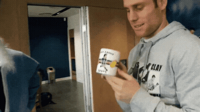 Man In Clay Shirt Holding Mug GIF