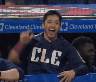 Man In Cle Shirt Sitting In Dugout GIF