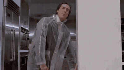 Man In Clear Plastic Coat Standing In Front Of Refrigerator GIF