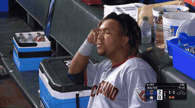 Man In Cleveland Jersey Sitting In Dugout GIF