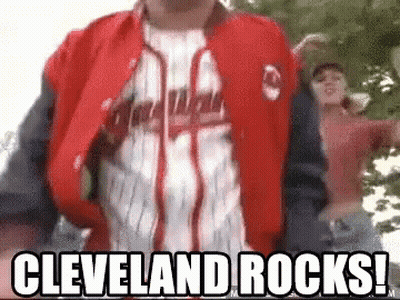 Man In Cleveland Rocks Jacket Next To Woman In Pink GIF