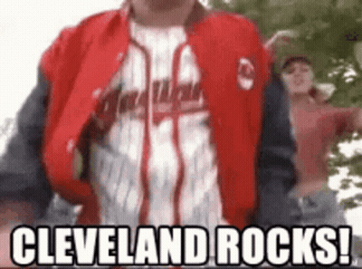 Man In Cleveland Rocks Jacket Standing In Front Of Tree GIF