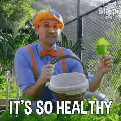 Man In Clown Costume Holding Basket Of Lettuce GIF