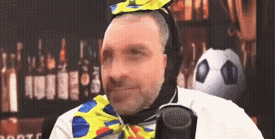 Man In Clown Costume Holding Microphone GIF