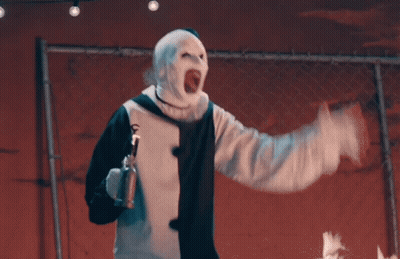 Man In Clown Costume Holding Spray Can GIF