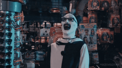 Man In Clown Costume In Front Of Face Booth Display GIF