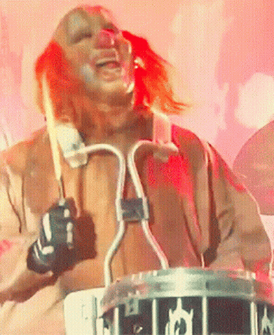 Man In Clown Costume Playing Drum Set GIF