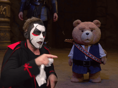 Man In Clown Costume Pointing At Teddy Bear GIF