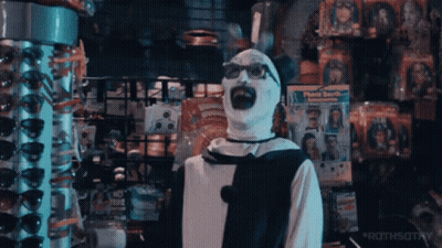 Man In Clown Costume Standing In Store GIF