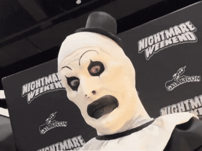 Man In Clown Costume Touched By Santa GIF