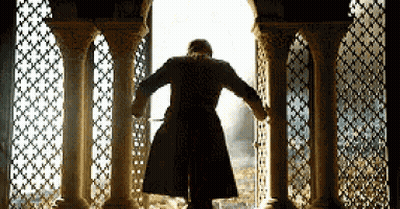 Man In Coat Looking Out Window GIF