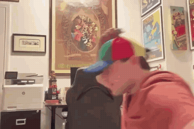 Man In Colorful Hat At Desk With HP Printer GIF