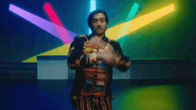 Man In Colorful Outfit Dancing In Front Of Lights GIF