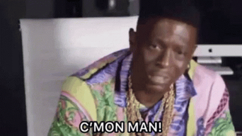 Man In Colorful Shirt And Gold Chains Sitting At Computer Says C Mon Man GIF
