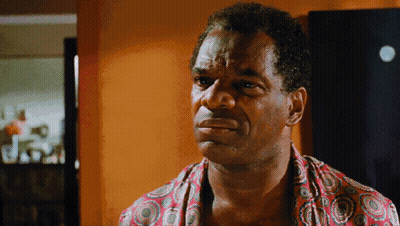 Man In Colorful Shirt Looking At Camera GIF