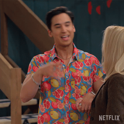 Man In Colorful Shirt Next To Woman With Netflix Logo GIF