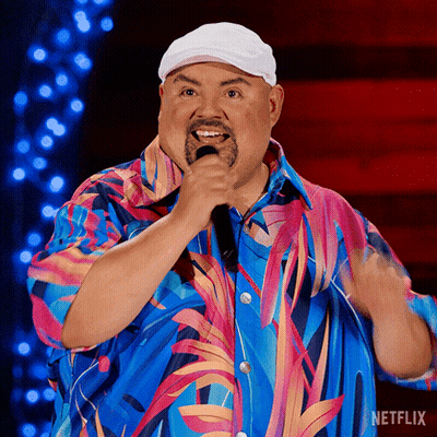 Man In Colorful Shirt Singing Into Microphone With Netflix Logo GIF