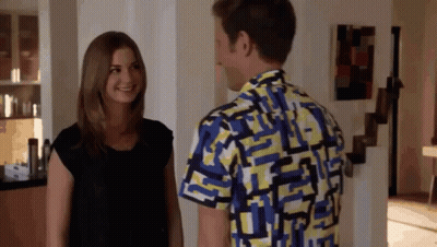 Man In Colorful Shirt Talks To Woman GIF