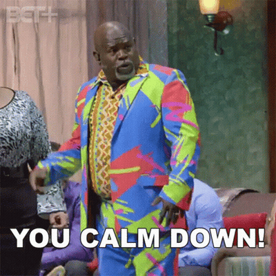 Man In Colorful Suit Says You Calm Down GIF