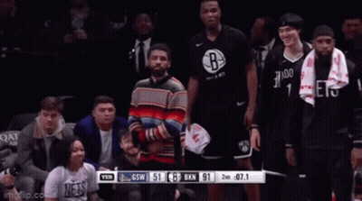 Man In Colorful Sweater In Front Of Brooklyn Nets GIF