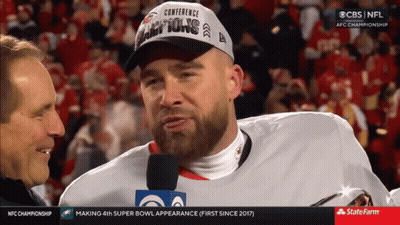 Man In Conference Champions Hat Interviewed By Reporter GIF