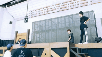 Man In Converse Shirt On Wooden Platform GIF