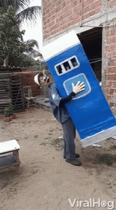Man In Costume Carrying Large Blue Lab Box GIF