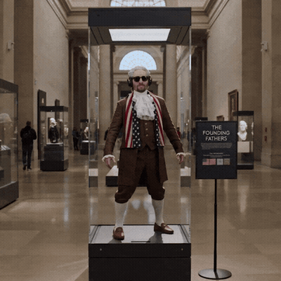 Man in Costume in Glass Case Saying The Founding Fathers