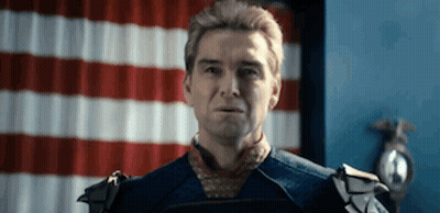 Man In Costume Standing Before American Flag GIF