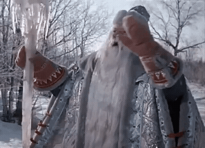Man In Costume With Beard Holding Ice Wand In Snow GIF
