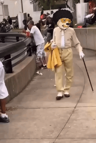 Man In Costume With Cane Walking GIF