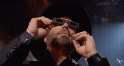 Man In Cowboy Hat And 3D Glasses Looking GIF