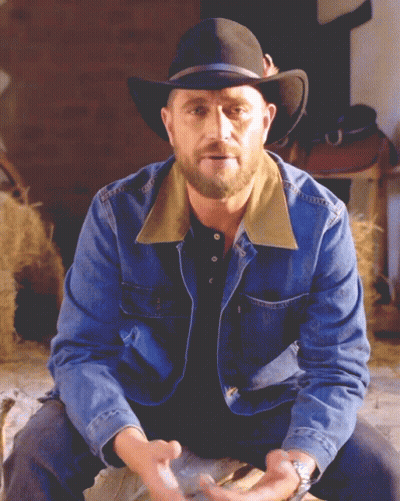 Man In Cowboy Hat And Denim Jacket Sitting GIF