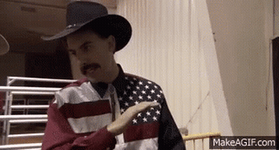 Man In Cowboy Hat And Flag Shirt Pointing GIF
