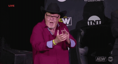 Man In Cowboy Hat And Glasses In Front Of AEW Wrestling Sign GIF