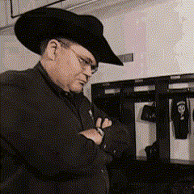 Man In Cowboy Hat And Glasses Looking Down GIF
