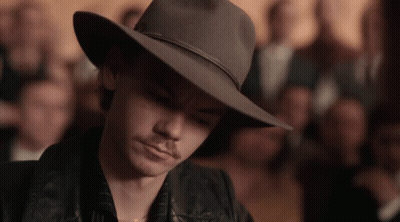 Man In Cowboy Hat And Leather Jacket Looking Down GIF